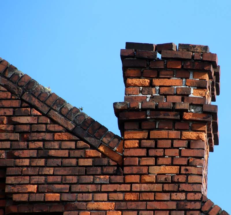 Damaged chimney on an Alsip home showing cracks and missing mortar